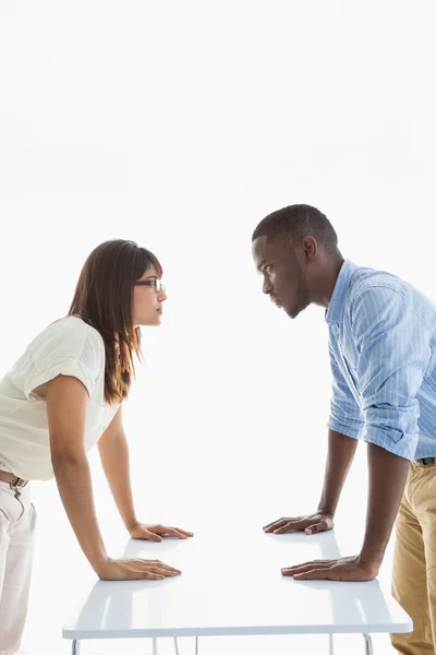 Business people having standoff at their desk — Stock Photo, Image