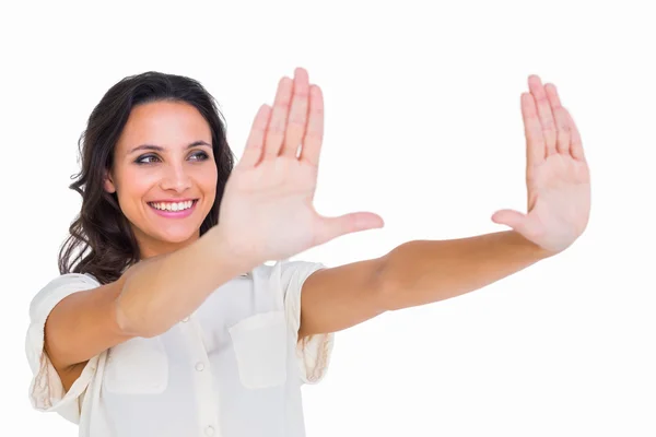 Pretty brunette holding up hands — Stock Photo, Image
