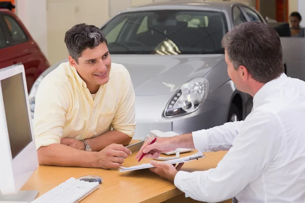 Salesman showing client where to sign deal — Stock Photo, Image