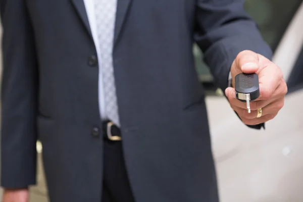 Close up of salesman givng a customer car keys — Stock Photo, Image