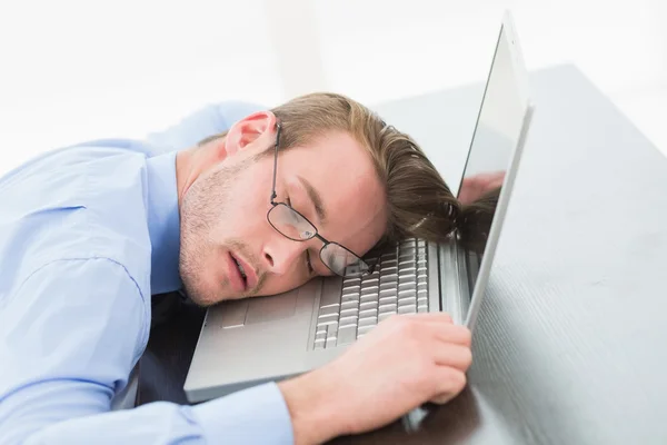 Businessman with glasses sleeping on laptop — Stock Photo, Image