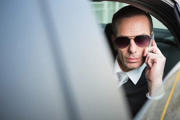 Businessman on the phone wearing sunglasses — Stock Photo, Image