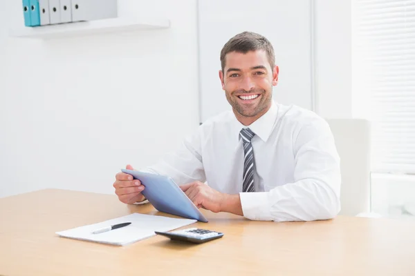 Empresário sorrindo usando seu tablet — Fotografia de Stock