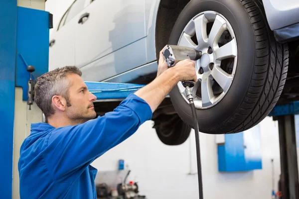 Mechanic adjusting the tire wheel Royalty Free Stock Images