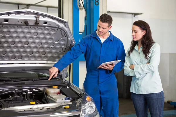 Mechanic showing customer problem with car Stock Picture