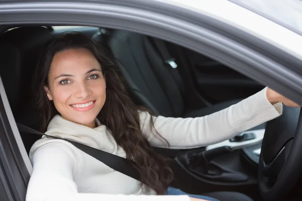 Pretty woman smiling and driving Royalty Free Stock Photos