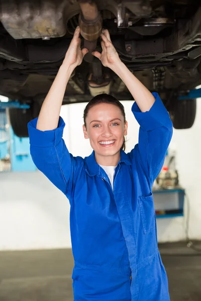 Mechanic examining under the car Stock Picture