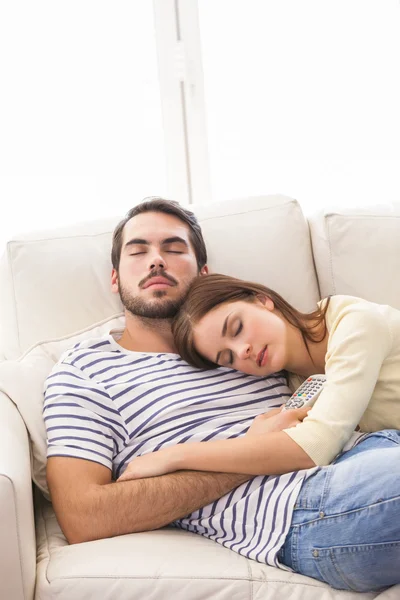 Cute couple napping on couch Stock Photo