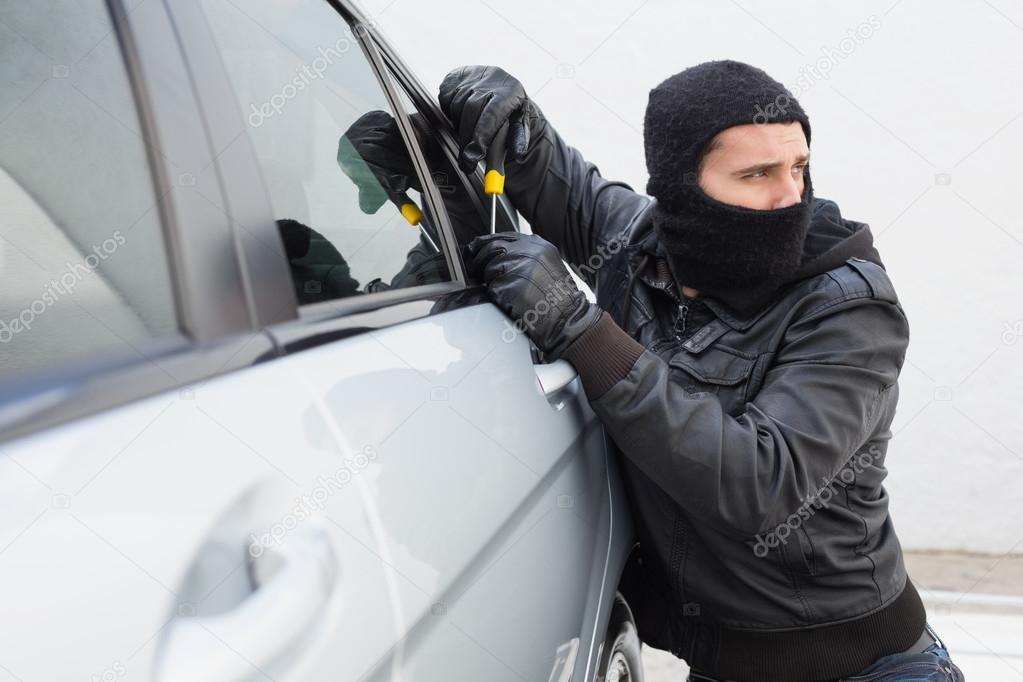 Thief Breaking Into A Car Stock Photo By C Wavebreakmedia