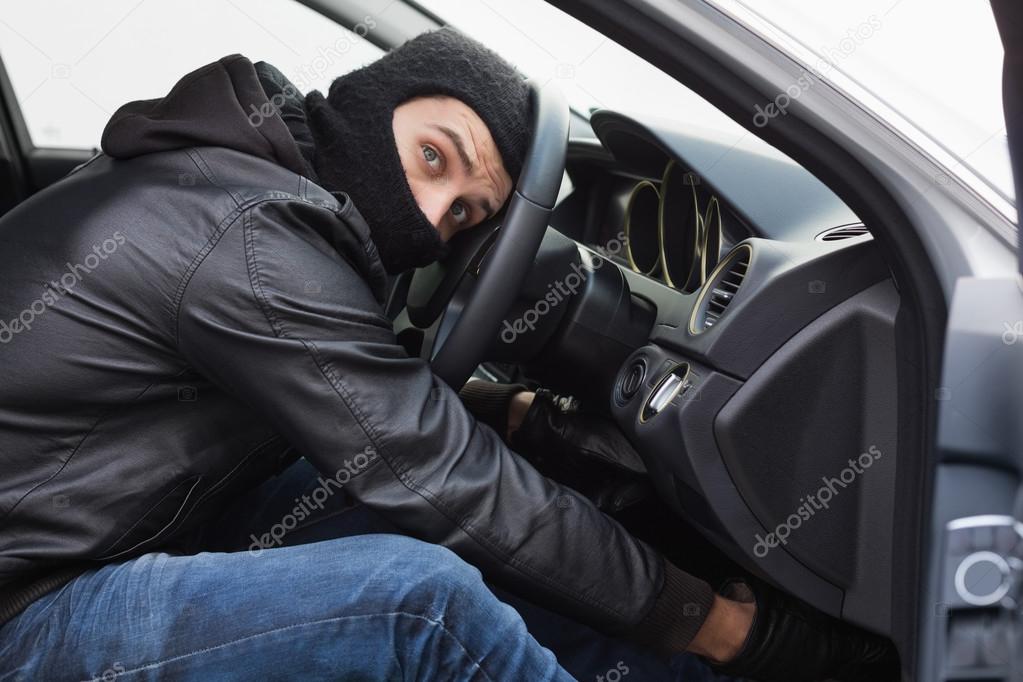 Thief breaking into a car Stock Photo by ©Wavebreakmedia 65558227