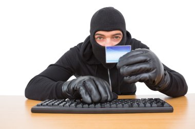 Hacker using card to steal identity clipart