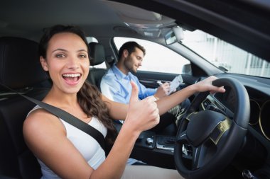 Young woman getting a driving lesson clipart