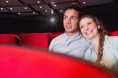 Young couple watching a film clipart