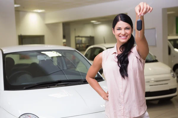 Smiling customer showing her new key — Stock Photo, Image