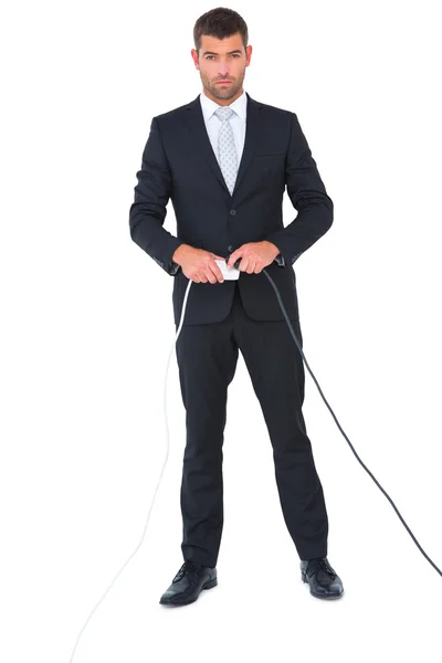 Serious businessman connecting a plug — Stock Photo, Image