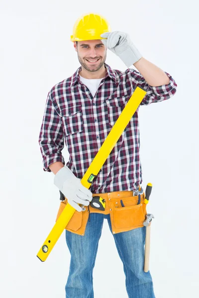 Confident handyman holding spirit level — Stock Photo, Image