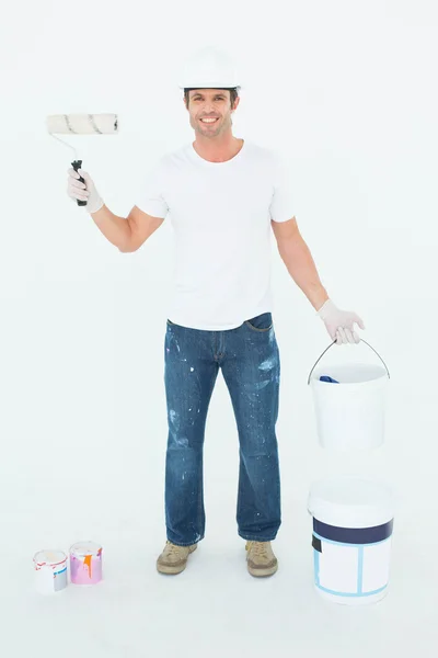 Happy man with paint roller and can — Stock Photo, Image