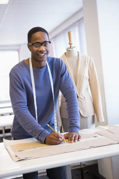 Smiling university student drawing patterns — Stock Photo, Image