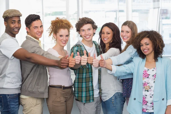 Fashion students showing thumbs up — Stock Photo, Image