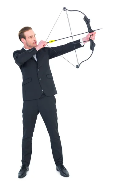 Focused businessman shooting a bow and arrow — Stock Photo, Image