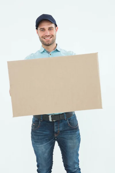 Courier man carrying cardboard box — Stock Photo, Image