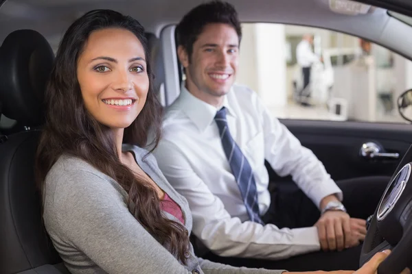 Feminino na roda no carro com vendedor — Fotografia de Stock