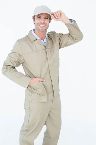 Happy delivery man holding cap — Stock Photo, Image