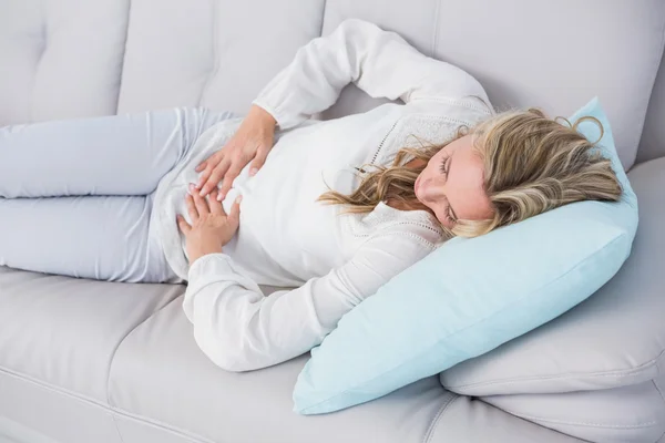 Blonde getting stomach pain — Stock Photo, Image