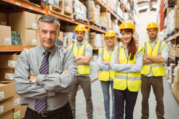 Smiling warehouse team with arms crossed — Stock Photo, Image