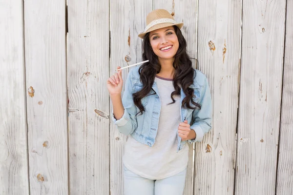 Pretty brunette thinking and smiling — Stock Photo, Image