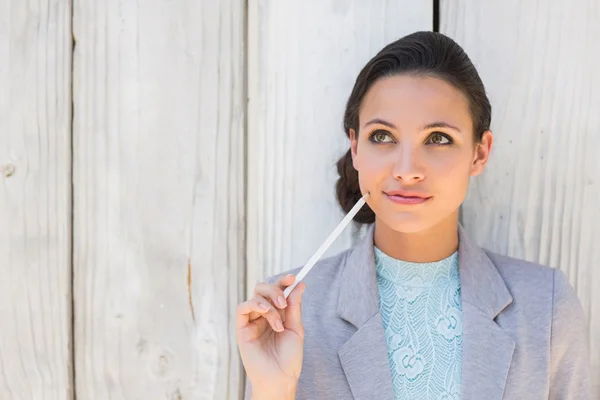 Stylish brunette thinking and smiling — Stock Photo, Image