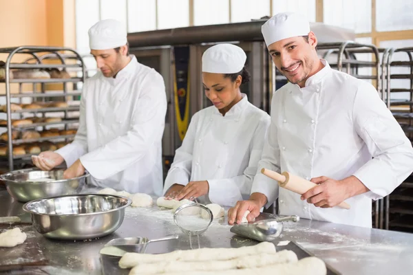 Team of bakers preparing dough — Stock Photo, Image