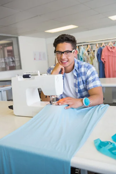 Smiling university student sewing — Stock Photo, Image