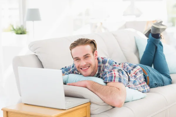 Man liggend op de Bank met behulp van laptop — Stockfoto