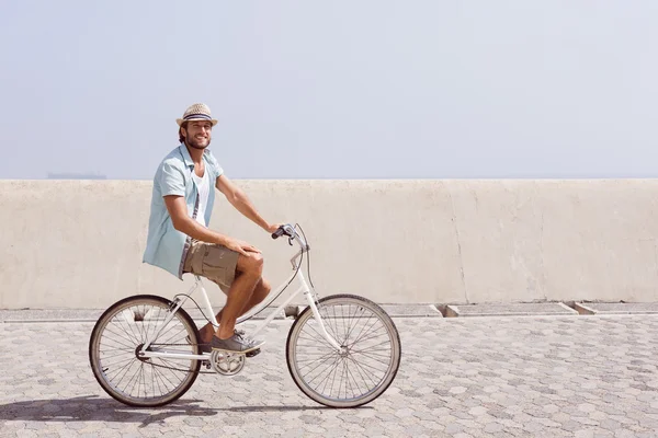 Handsome man on a bike ride — Stock Photo, Image