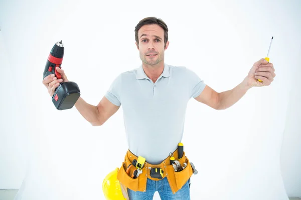 Technician holding screwdriver and drill machine — Stock Photo, Image