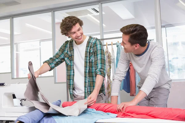 Students working together with a fabric — Stock Photo, Image