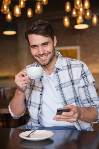 Young man having cup of coffee — Stock Photo, Image