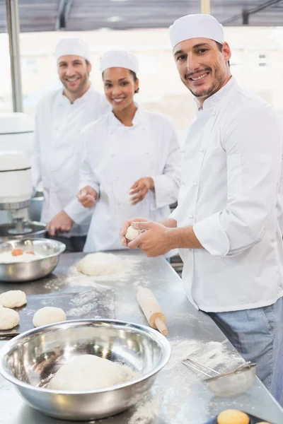Team of bakers working at counter — Stock Photo, Image