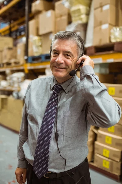 Gerente sonriente hablando con auriculares — Foto de Stock