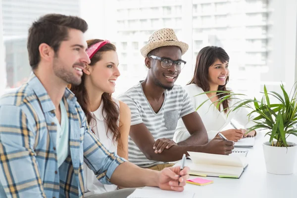 Smiling teamwork sitting and taking notes — Stock Photo, Image