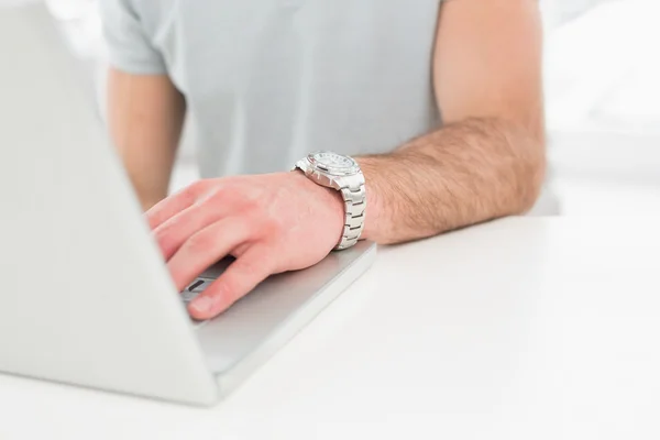 Businessman with watch using laptop — Stock Photo, Image