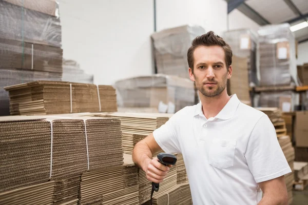 Serious warehouse worker holding scanner — Stock Photo, Image