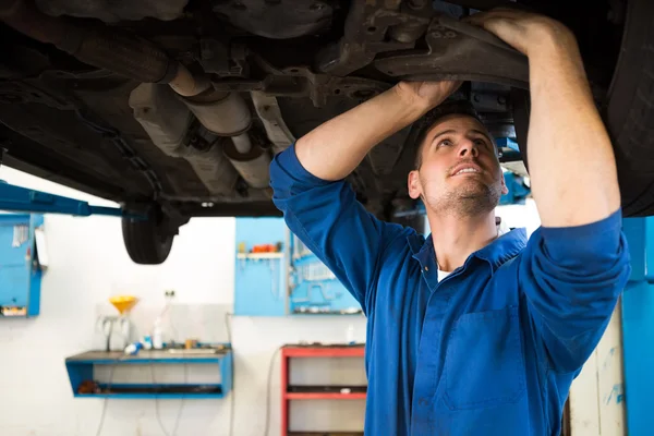 Mecánico examinando debajo del coche — Foto de Stock