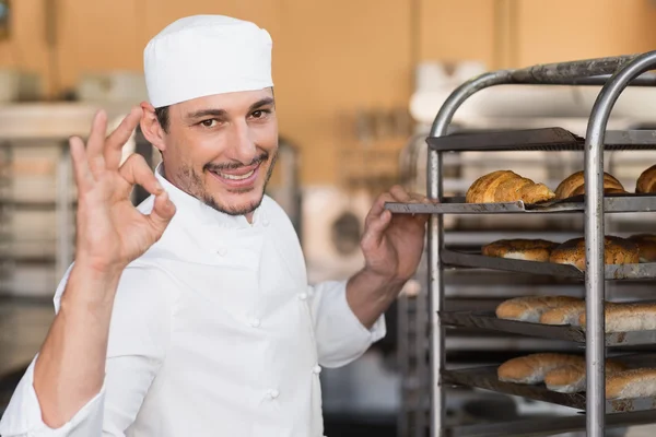 Baker checking freshly baked bread — Stock Photo, Image