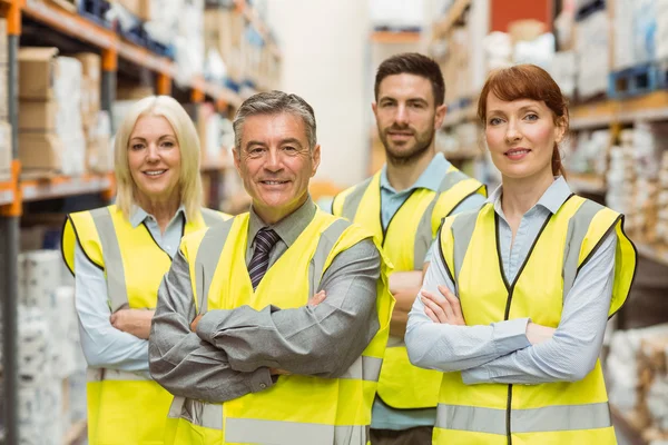 Smiling warehouse team with arms crossed — Stock Photo, Image