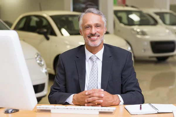 Smiling businessman sitting at his desk — Stock Photo, Image