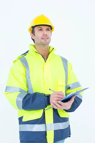 Male architect writing on clipboard — Stock Photo, Image