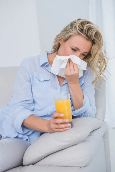 Blonde sneezing on tissue — Stock Photo, Image