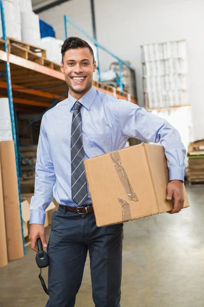 Warehouse manager holding cardboard box — Stock Photo, Image